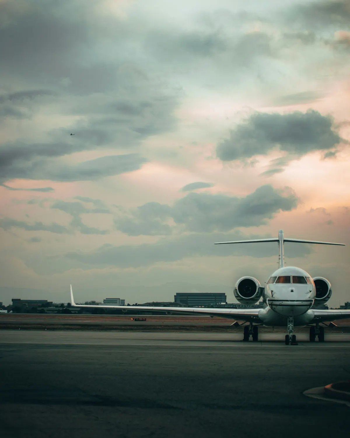 Business jet waiting on an apron at dusk